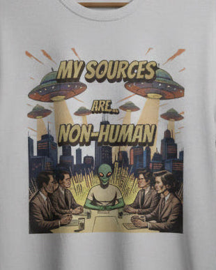 T-shirt with alien abduction graphic and text on a gray couch